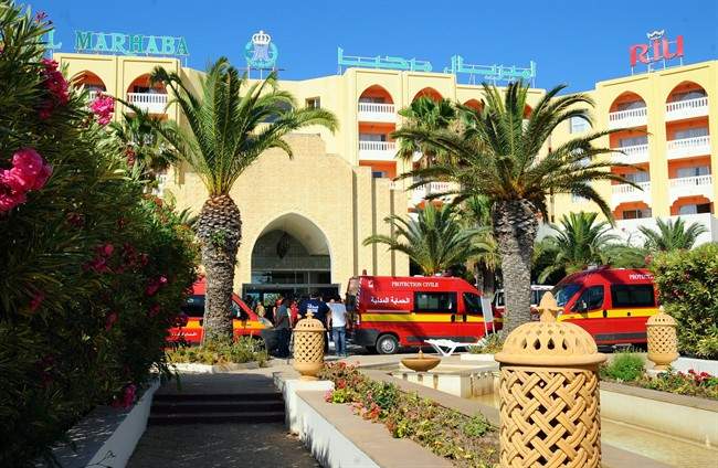 Injured people are treated near the area where an attack took place in Sousse, Tunisia, Friday June 26, 2015.