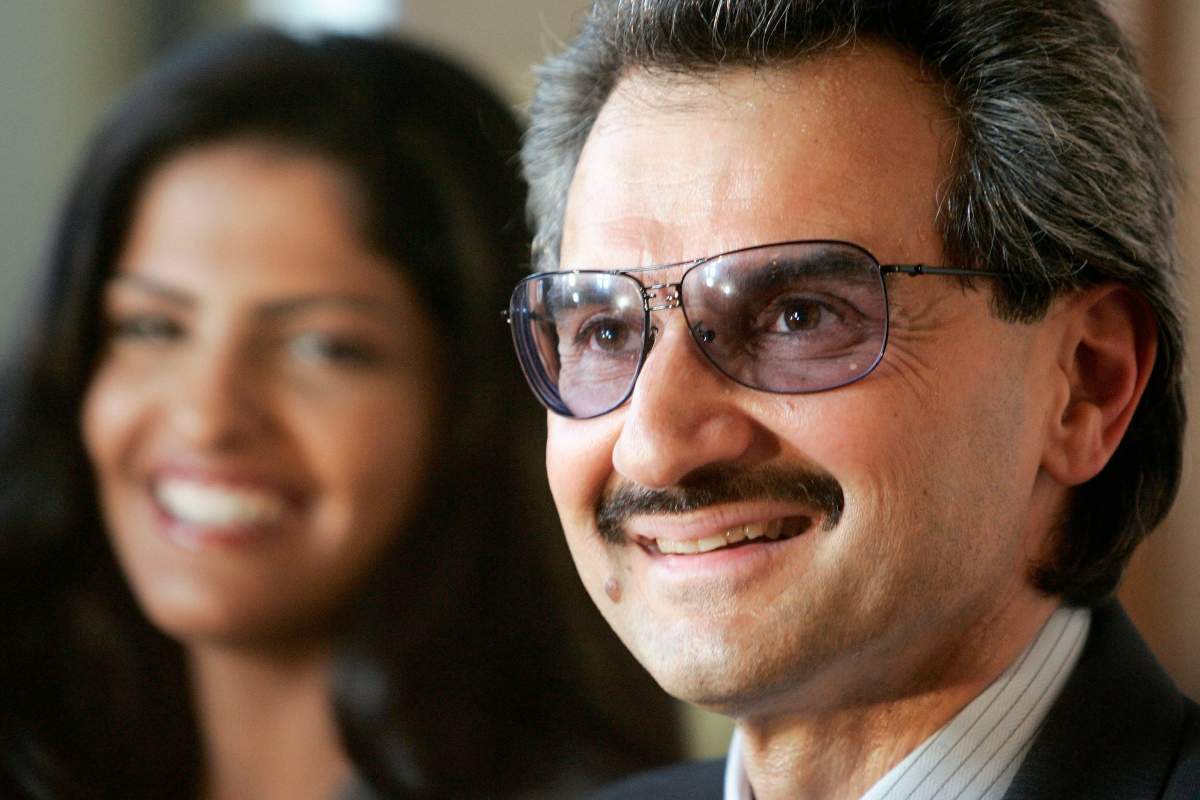 Saudi Arabia's Prince Alwaleed bin Talal delivers a speech as his wife, Princess Amira, looks on, after he received the medal of Great Patron of the French Culture Ministry during a ceremony at the Louvre museum in Paris, France.