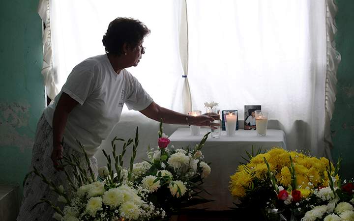A woman arranges an altar at the home of journalist Juan Mendoza Delgado as relatives wait for the arrival of the coffin containing his remains in the town of Medellin, state of Veracruz, Mexico. According to police authorities, Delgado was killed in a hit and run but his family and human rights groups are demanding a full investigation.