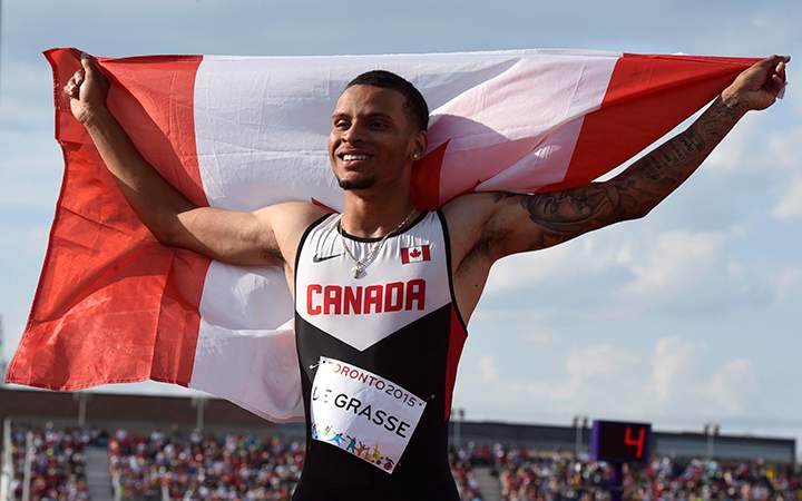 Andre De Grasse, of Canada, smiles after winning gold in the 200m final during the athletics competition at the 2015 Pan Am Games in Toronto on Friday, July 24, 2015.