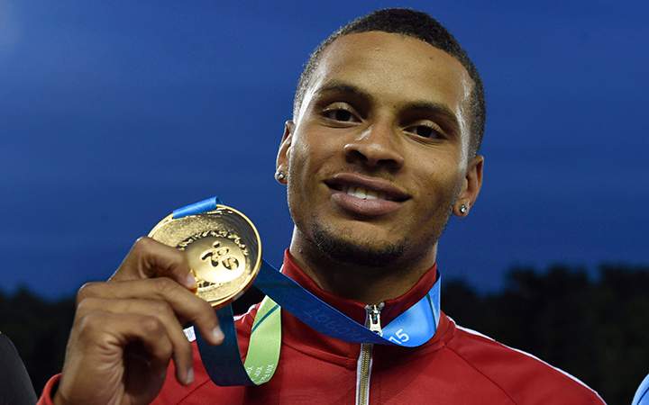 Andre De Grasse, of Canada, holds his gold medal after winning the men's 200m final during the athletics competition at the 2015 Pan Am Games in Toronto on Friday, July 24, 2015.