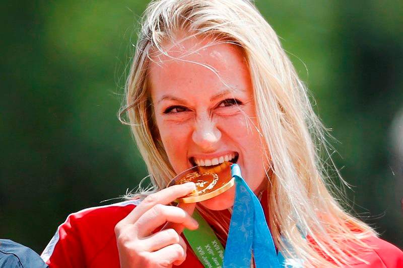 Elizabeth Gleadle of Canada celebrates with her gold medal in javelin during the athletics competition at the Pan Am Games in Toronto, Tuesday July 21, 2015.