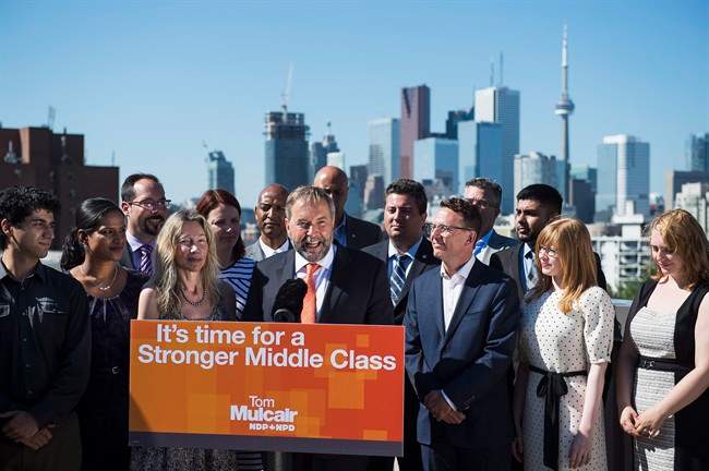 NDP leader Tom Mulcair, seen here campaigning in Ontario, has touted his plan to create a federal minimum wage of $15 per hour.