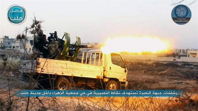 In this image posted on the Twitter page of Syria's al-Qaida-linked Nusra Front on early Tuesday, July 7, 2015, a fighter from the Nusra Front fires a weapon during clashes against the Syrian government forces at the western Zahra neighborhood in Aleppo city, Syria. 