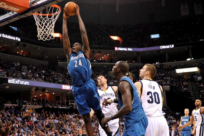 Minnesota Timberwolves forward Anthony Bennett (24) dunks the ball past Memphis Grizzlies guard Beno Udrih, from left, Minnesota Timberwolves center Gorgui Dieng, and Memphis Grizzlies forward Jon Leuer (30) in the second half of an NBA basketball game Wednesday, Oct. 29, 2014, in Memphis, Tenn. 