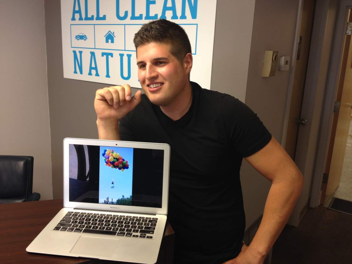 Daniel Boria shows footage of his Stampede stunt on a laptop.