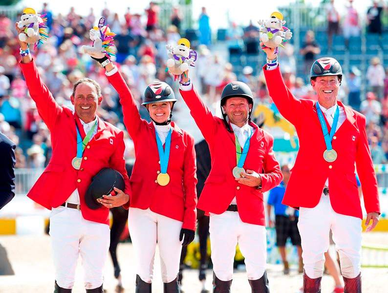 Canadian Equestrian team pictured left to right, Yann Candele, Tiffany Foster, Eric Lamaze and Ian Millar show off their gold medals after winning the team jumping during the Pan American Games in Caledon, Ont., on Thursday, July 23, 2015.