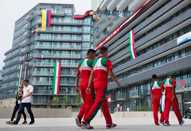 Flags are hung outside windows as athletes make their way through the athletes' village at the 2015 Pan Am Games in Toronto.