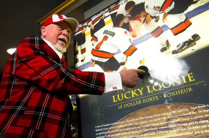 Hockey commentator Don Cherry becomes the first person to touch the Lucky Loonie after its removal from protective casing at the Hockey Hall of Fame in Toronto Monday, February 1, 2010.
