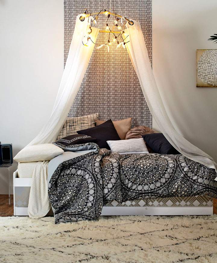 This photo provided by courtesy of Wayfair and Laura Moss Photography shows a dorm room. It's a design dream and a challenge: how to outfit a small, nondescript college dorm room. DwellStudio founder and creative director Christiane Lemieux's tips include creating a chandelier with a hula hoop, duct tape, two curtain panels, a string of lights and washi tape. Instructions are in Lemieux's "Industrial Bohemian Luxe" YouTube tutorial.