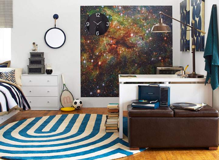 This photo provided by courtesy of Wayfair and Laura Moss Photography shows a dorm room. It's a design dream and a challenge: how to outfit a small, nondescript college dorm room. DwellStudio founder and creative director Christiane Lemieux's tips include hanging a temporary, adhesive mural and incorporating attractive bedding that coordinates with the room.