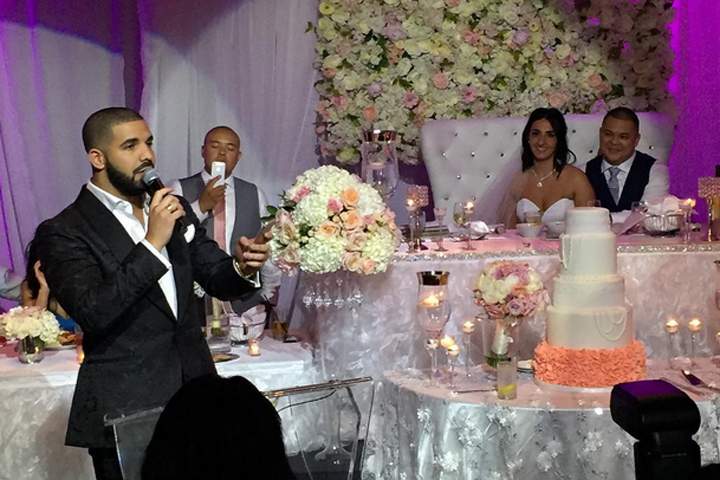 Drake toasts the newlyweds on July 16, 2015.