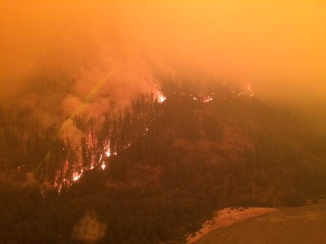 Thick smoke creates a hazy, orange atmosphere in Elaho, B.C.