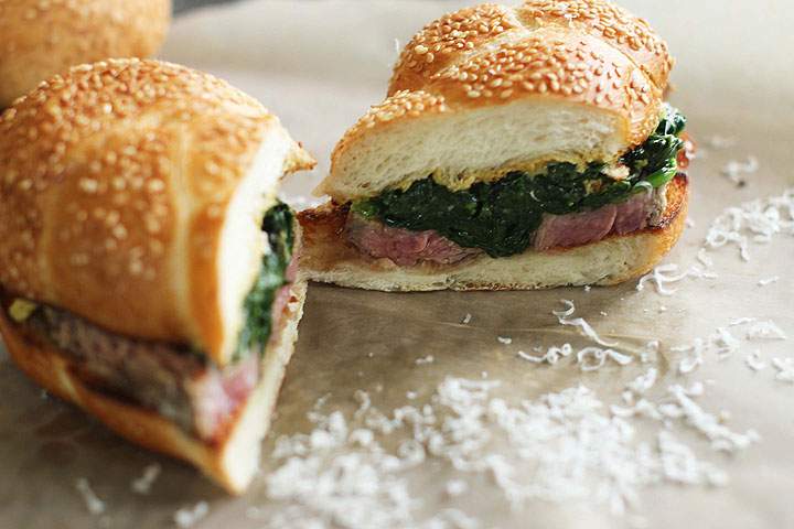 This June 15, 2015 photo shows marinated flank steak with seared spinach in Concord, N.H. This dish is from a recipe by Alison Ladman.