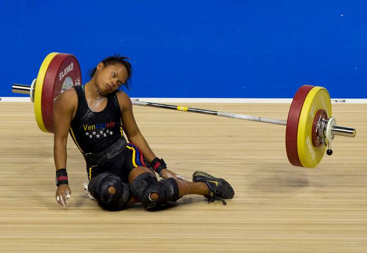 Venezuela's Genesis Rodriguez Gomez collapses during a lift attempt in the women's 53kg weightlifting at the Pan Am Games in Oshawa, Ontario, Sunday, July 12, 2015.