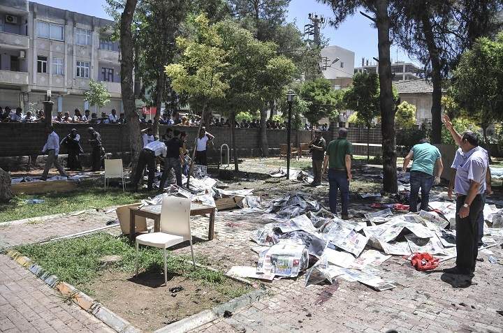 People gather at the site of an explosion in Suruc district of Sanliurfa, Turkey on July 20, 2015. Casualties reported after an explosion in southeastern Turkish province of Sanliurfa bordering Syria. (Photo by Rauf Maltas/Anadolu Agency/Getty Images).