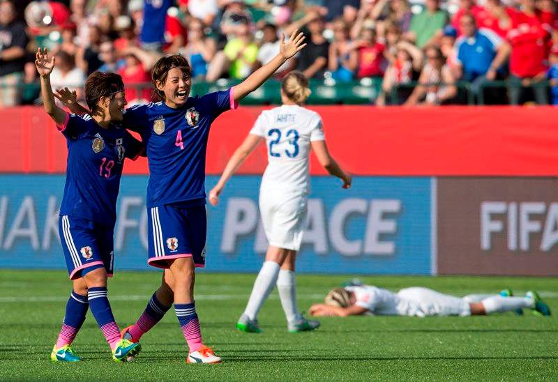 Japan's Saori Ariyoshi (19) and Saki Kumagai (4) celebrate the win over England in FIFA Women's World Cup semi-final soccer action in Edmonton on Wednesday July 1, 2015.