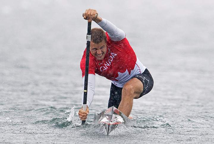 Canada’s Jason McCoombs paddles through rain on his way to win a silver medal in the men’s C1 200m canoe race at the 2015 Pan Am Games in Welland, Ont. on Tuesday, July 14, 2015.