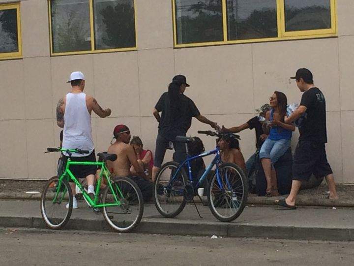 John Tonner (L) hands out water to homeless Edmontonians Sunday, July 12, 2015.