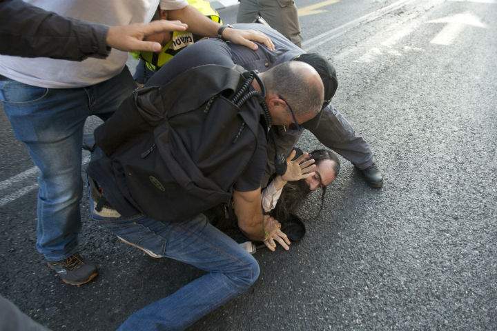 Police arrest an ultra-Orthodox Jew after he attacked people with a knife during a Gay Pride parade Thursday, July 30, 2015 in central Jerusalem. Israeli police said several people were stabbed.