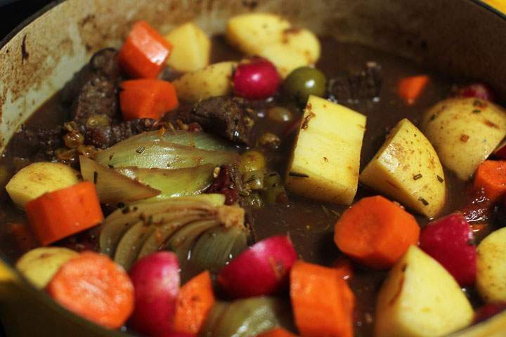 This June 15, 2015 photo shows baked mediterranean lamb stew in Concord, N.H. This dish is from a recipe by Alison Ladman.