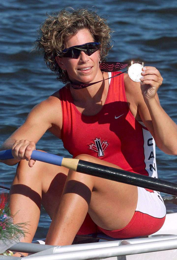 Marnie McBean show off her gold medal at the Pan American Games in Lake Minnedosa, Man. in this July 28, 1999 photo.