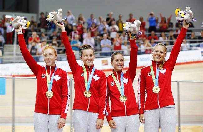 Canada's left to right, Allison Beveridge, Laura Brown, Jasmin Glaesser, and Kirsti Lay celebrate with their gold medals following the track cycling women's team pursuit finals at the Pan Am Games in Milton, Ont., Friday July 17, 2015.