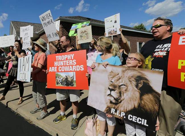 Protestors gather outside Dr. Walter James Palmer\’s dental office in Bloomington, Minn., Wednesday, July 29, 2015.