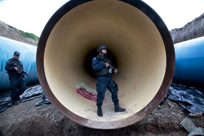 Federal police guard a drainage pipe outside of the Altiplano maximum security prison in Almoloya, west of Mexico City, Sunday, July 12, 2015.