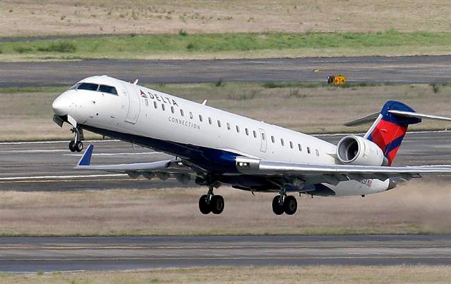 In this photo taken, Tuesday, March 24, 2015, a Delta jet takes off from Seattle-Tacoma International Airport in SeaTac, Wash.