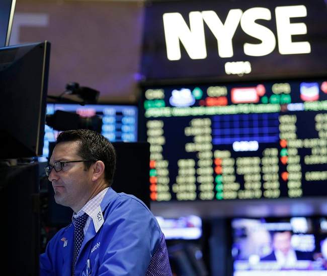 Traders work on the floor at the New York Stock Exchange.