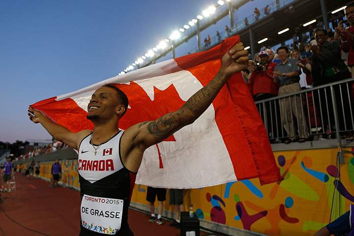 Canada’s Andre de Grasse celebrates after winning the final of the men’s 100m race at the Pan Am Games in Toronto on Wednesday, July 22, 2015.