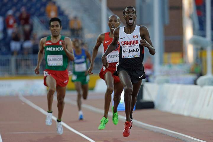 Canada’s Ahmed Mohammed sticks out his tongue as he crosses the finish line during the finals of the men’s 10,000m run at the Pan Am Games Tuesday on July 21, 2015, in Toronto.