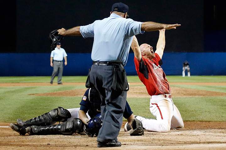 Canada’s Peter Orr reacts after scoring the game-winning run under the tag of United States catcher Thomas Murphy’s in the 10th inning of the gold medal baseball game at the Pan Am Games in Ajax, Ontario on Sunday, July 19, 2015.
