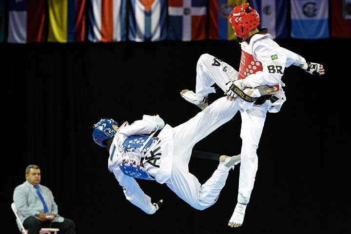 Argentina’s Lucas Guzman, left, fights against Brazil’s Venilton Torres during a men’s -58kg bronze medal taekwondo match at the Pan Am Games in Mississauga, Ontario on Sunday, July 19, 2015.