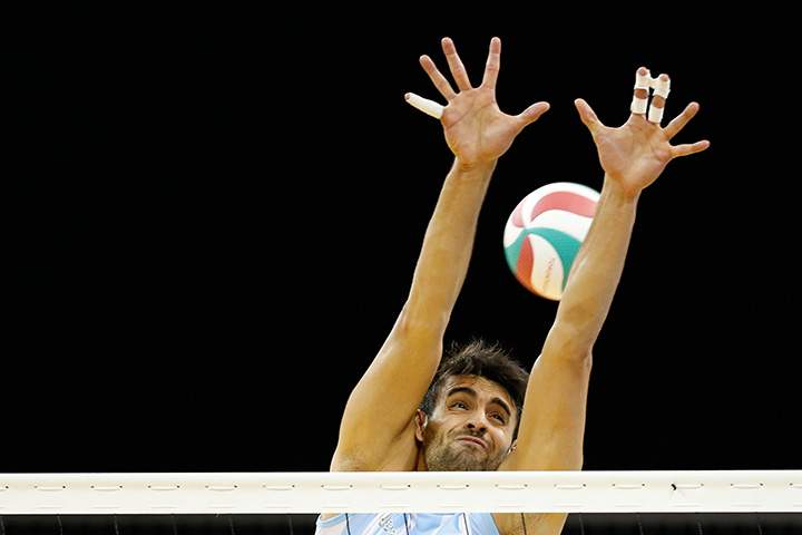 Argentina’s Sebastian Sole fails to block a spike by Canada’s Gavin Schmitt during a men’s volleyball semi-final match at the Pan Am Games in Toronto on Friday, July 24, 2015.