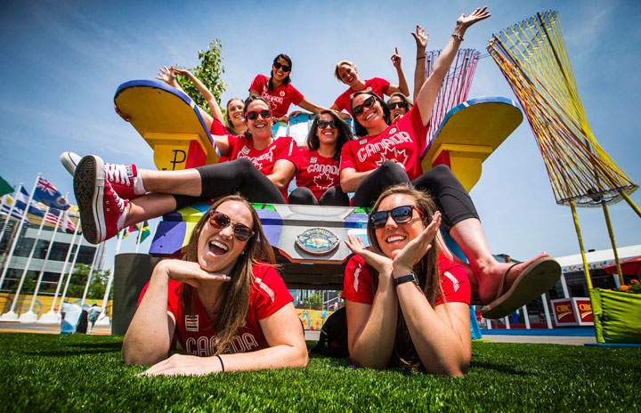 The Canadian women's water polo team poses for a picture on a giant chair inside the Pan American Games athletes village in Toronto, Friday July 3, 2015.