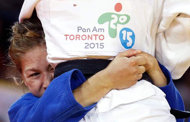 Canada’s Catherine Beauchemin-Pinard grabs onto United States’ Marti Malloy during the women’s -57kg gold medal match at the Pan Am Games on Sunday, July 12, 2015, in Mississauga, Ontario.