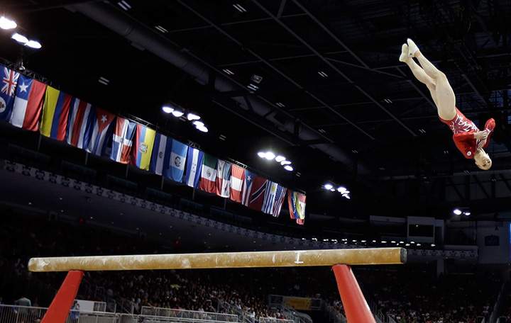 Canada’s Ellie Black leaps above the balance beam as she dismounts during women’s artistic gymnastics team competition in the Pan Am Games in Toronto on Sunday, July 12, 2015.