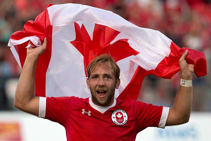 Canada’s Sean White waves a Canadian flag after Canada beat Argentina 22-19 to win the gold medal in the men’s rugby sevens at the Pan Am Games in Toronto on Sunday, July 12, 2015.