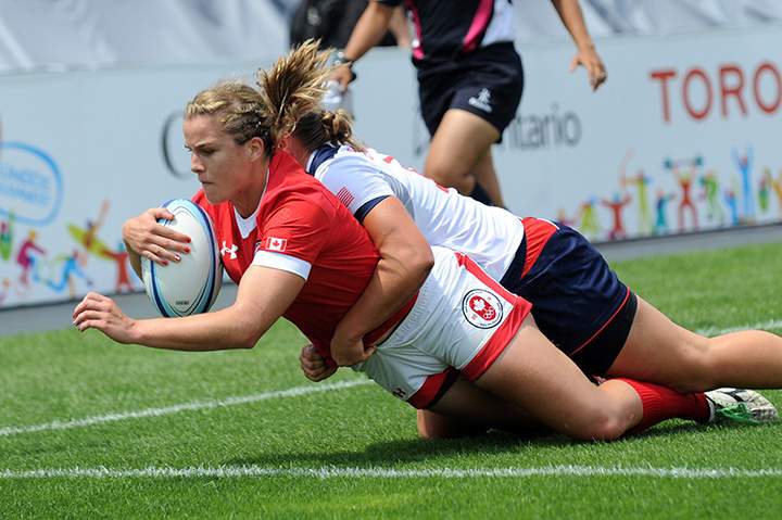 Canada’s Nadejda Popov (L) vies for the ball with Kate Zackary (R) of USA during the Rugby 7 Preliminary Round Match at the Toronto 2015 Pan American Games on July 12, 2015.