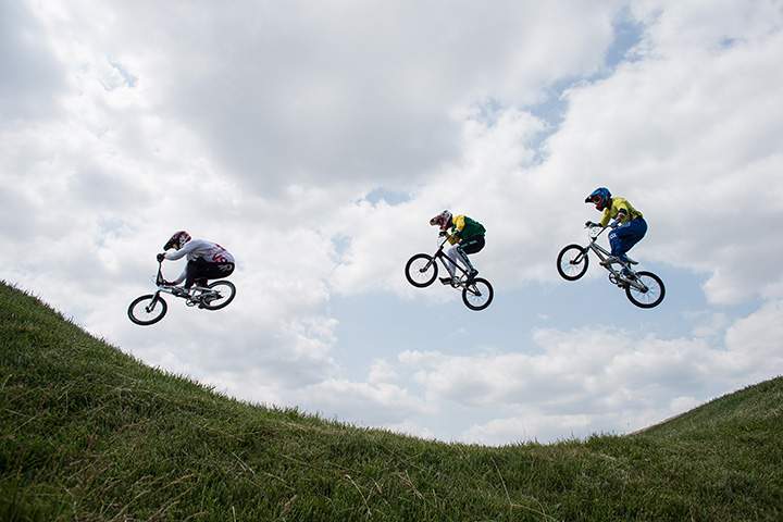 Cylists clear a jump during the BMX competition at the 2015 Pan American Games in Toronto on July 11, 2015.
