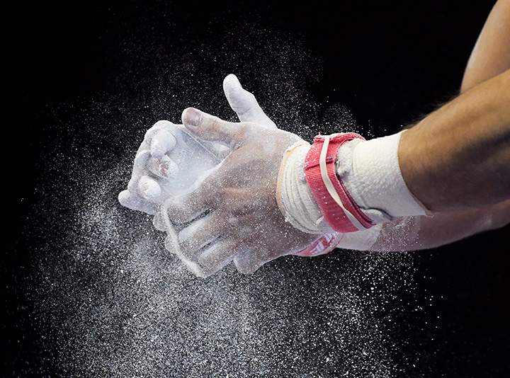 Samuel Mikulak of the United States applies chalk to his hands before high bar at the men’s all-around gymnastics competition during the Pan Am Games in Toronto on Monday, July 13, 2015.