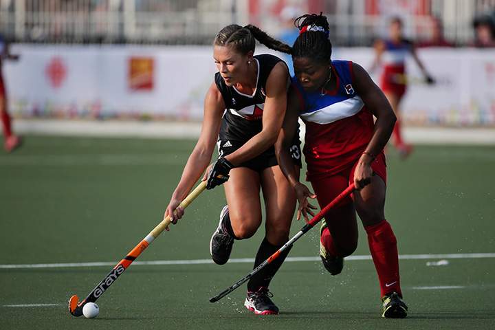 Canada’s Brienne Stairs, left, fights for the ball with Dominican Republic’s Albania Marte during the women’s Field Hockey competition at the Pan Am Games in Toronto, Ontario on Monday, July 13, 2015.