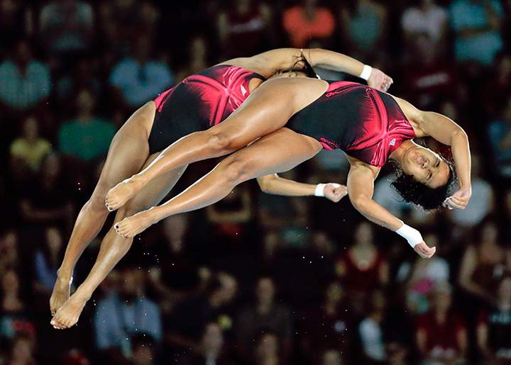 Annia Rivera and Yaima Mena of Cuba compete during the women’s synchronized 10-meter platform diving event at the Pan Am Games in Toronto on Monday, July 13, 2015.