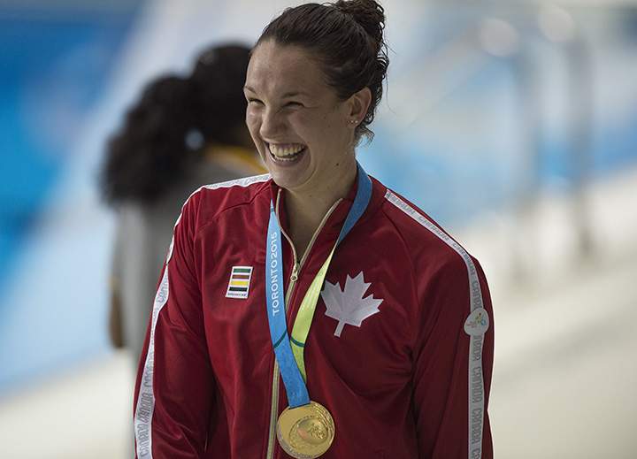 Canada’s Chantal Van Landeghem celebrates winning the gold medal in the Women’s 100M Freestyle finals at the 2015 Pan American Games in Toronto, Canada, July 14, 2015.