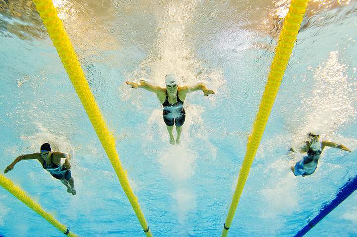 Canada’s Audrey Lacroix (C) of Canada, Andreina Pinto (L) of Venezuela and Isabella Paez (R) of Venezuela compete in the Women’s 200m Butterfly Preliminaries at the Pan American games on July 14, 2015 in Toronto.