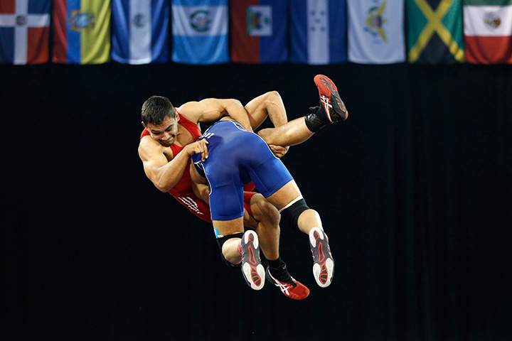 Costa Rica’s Johnathan Scott, back, is dropped by Venezuela’s Cristian Sacro during a men’s freestyle 74 kg bronze medal wrestling match at the Pan Am Games, Saturday, July 18, 2015, in Mississauga, Ontario.