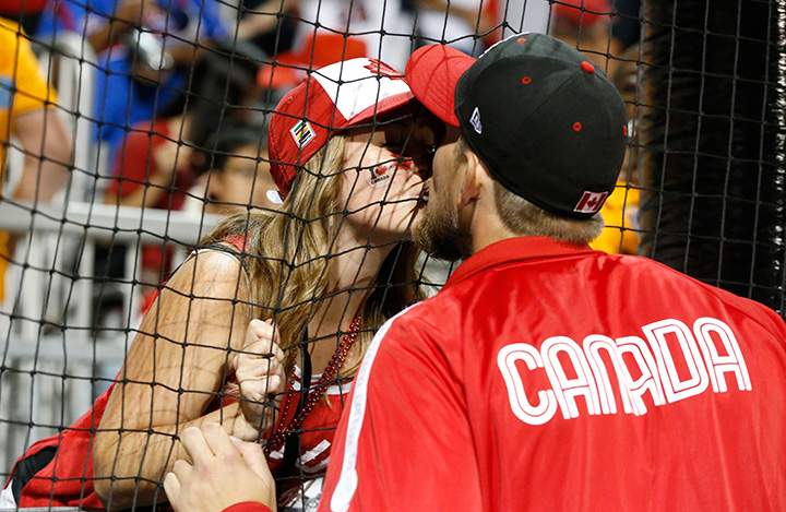 Canada’s Jordan Lennerton, right, gives a kiss to his fiancée Ashley Swistzew after he was awarded the gold medal during the baseball tournament medal ceremony at the Pan Am Games, Sunday, July 19, 2015, in Ajax, Ontario.