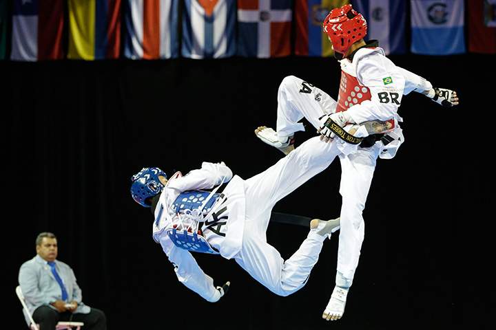 Argentina’s Lucas Guzman, left, fights against Brazil’s Venilton Torres during a men’s -58kg bronze medal taekwondo match at the Pan Am Games in Mississauga, Ontario, Sunday, July 19, 2015.